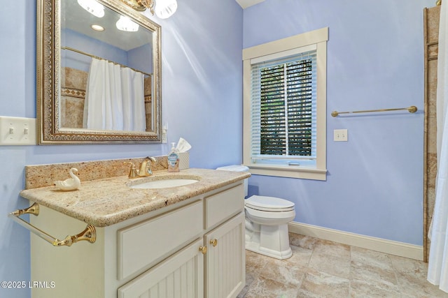 bathroom featuring curtained shower, toilet, vanity, and baseboards