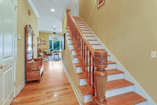 stairs featuring a ceiling fan, wood finished floors, recessed lighting, crown molding, and baseboards