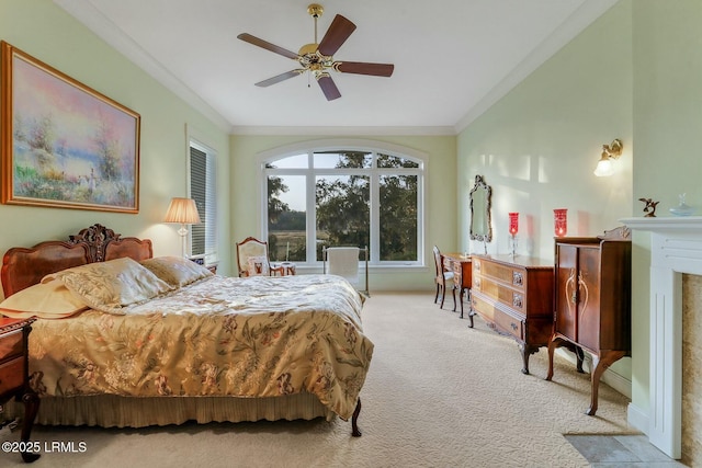 bedroom featuring ceiling fan, vaulted ceiling, carpet flooring, and crown molding