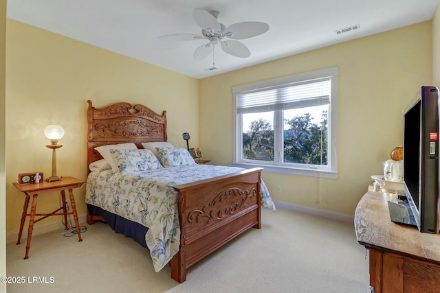 carpeted bedroom with visible vents, a ceiling fan, and baseboards