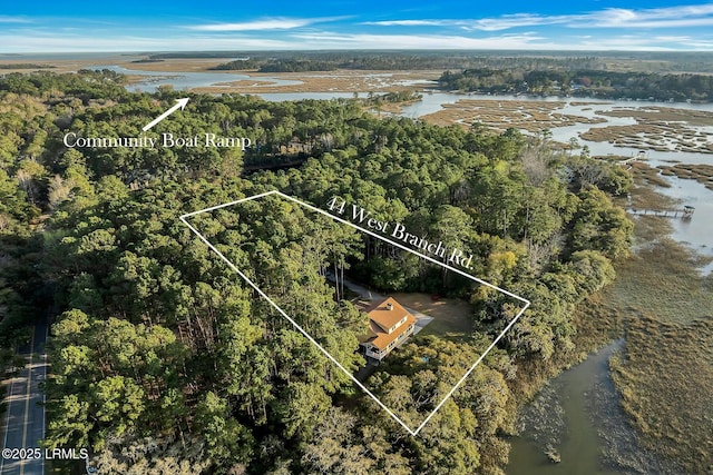 bird's eye view featuring a forest view and a water view