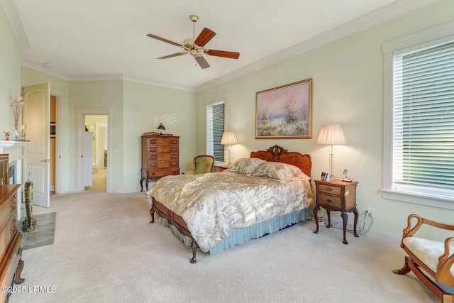 carpeted bedroom featuring a ceiling fan, crown molding, a fireplace, and baseboards