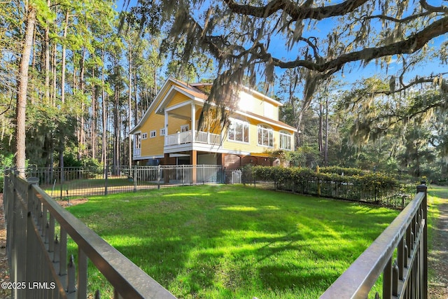 back of house with a yard, a balcony, and fence private yard