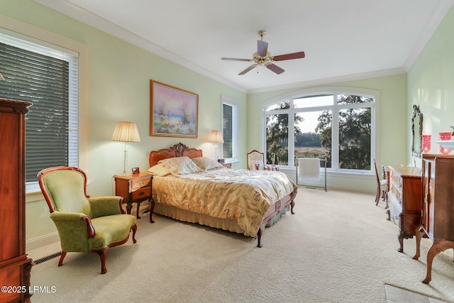 bedroom featuring a ceiling fan, carpet, visible vents, baseboards, and crown molding