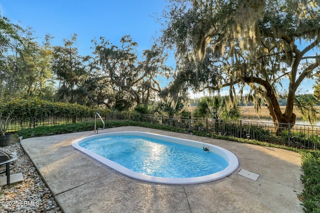 view of swimming pool with a fenced in pool, a patio, and fence