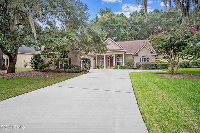 view of front of house with a garage and a front yard