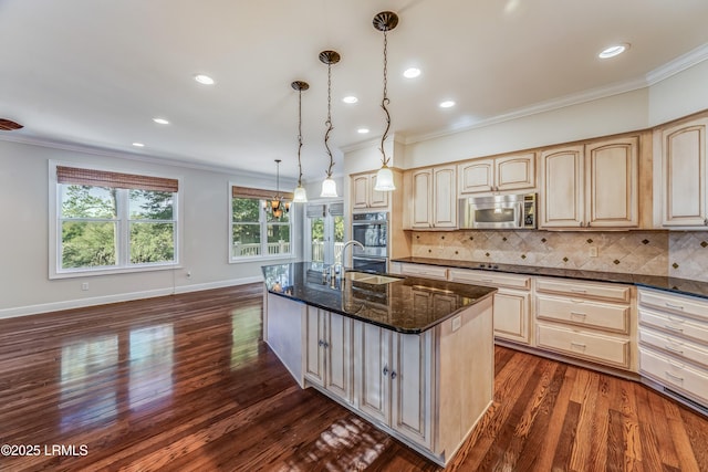 77 Tuscarora Ave, Beaufort, SC 29907 - kitchen with ornamental molding, dark stone countertops, dark wood-type flooring, appliances with stainless steel finishes, and light brown cabinetry