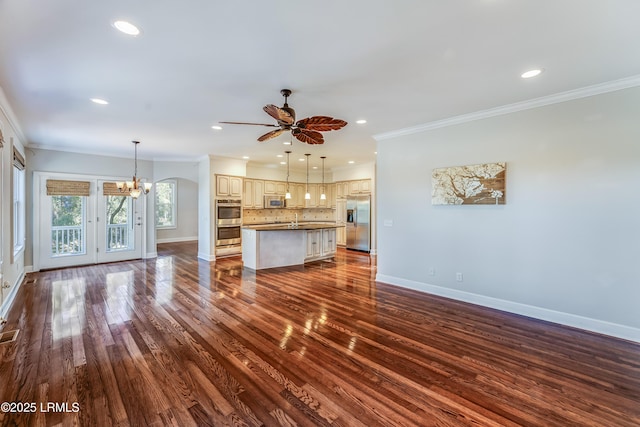 77 Tuscarora Ave, Beaufort, SC 29907 - unfurnished living room with baseboards, ornamental molding, dark wood finished floors, recessed lighting, and ceiling fan with notable chandelier