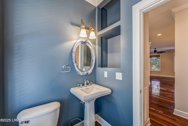 77 Tuscarora Ave, Beaufort, SC 29907 - half bathroom featuring toilet, wood finished floors, a sink, and baseboards