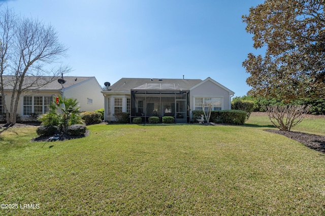 back of property with a lawn and a sunroom