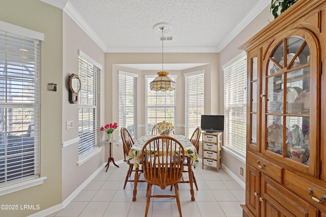 dining area with light tile patterned floors, visible vents, baseboards, and ornamental molding