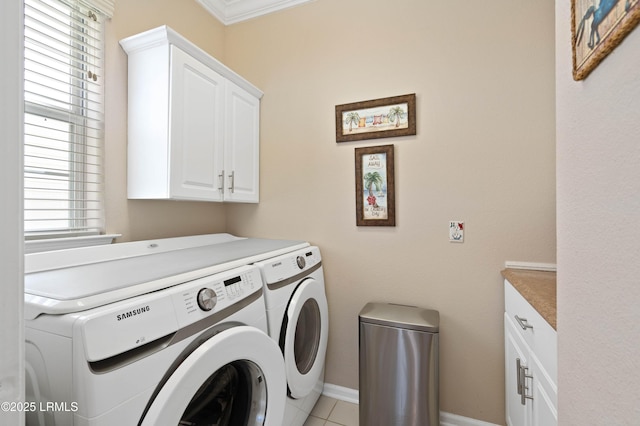 laundry area with baseboards, cabinet space, and washer and clothes dryer