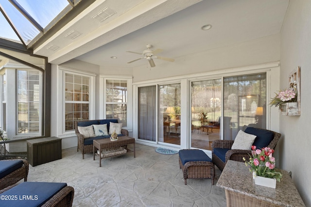 sunroom featuring visible vents, ceiling fan, and outdoor lounge area