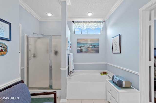 bathroom featuring a bath, a shower stall, and a textured ceiling