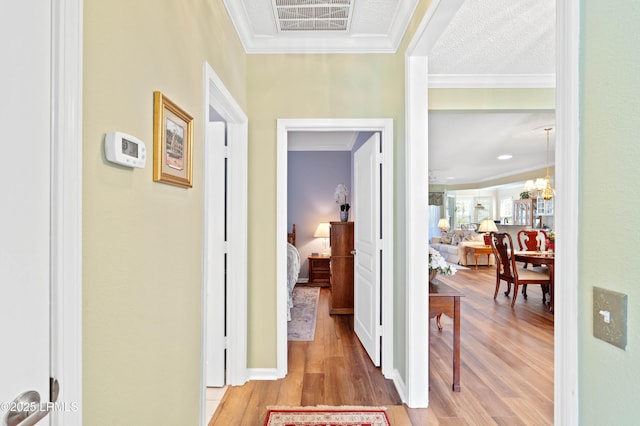 hall featuring wood finished floors and ornamental molding