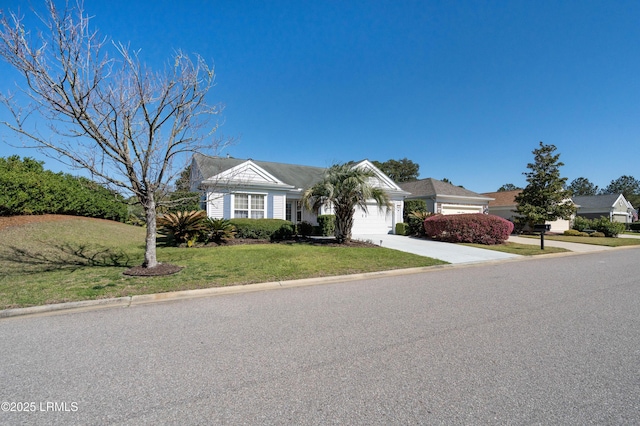 view of front of home featuring an attached garage, driveway, and a front yard