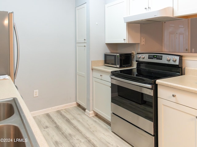 kitchen with white cabinetry, light wood-type flooring, and appliances with stainless steel finishes