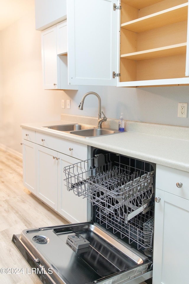 kitchen with sink, light hardwood / wood-style floors, and white cabinets