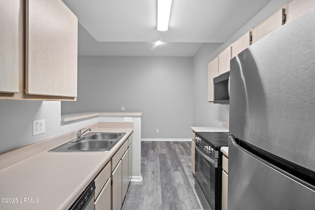 897 Fording Island Rd Unit 209, Bluffton, SC 29910 - kitchen with stainless steel appliances, a sink, dark wood finished floors, light countertops, and light brown cabinets
