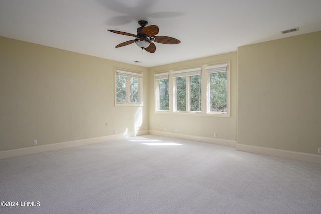 empty room with ceiling fan and light colored carpet