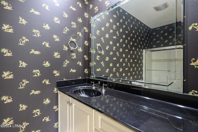 bathroom featuring wallpapered walls, vanity, and visible vents