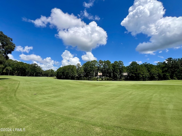 view of home's community featuring a yard and view of golf course