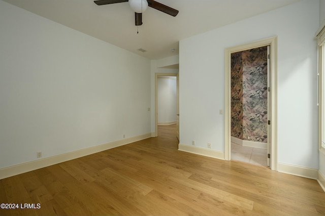 unfurnished bedroom featuring ensuite bathroom, ceiling fan, and light hardwood / wood-style floors