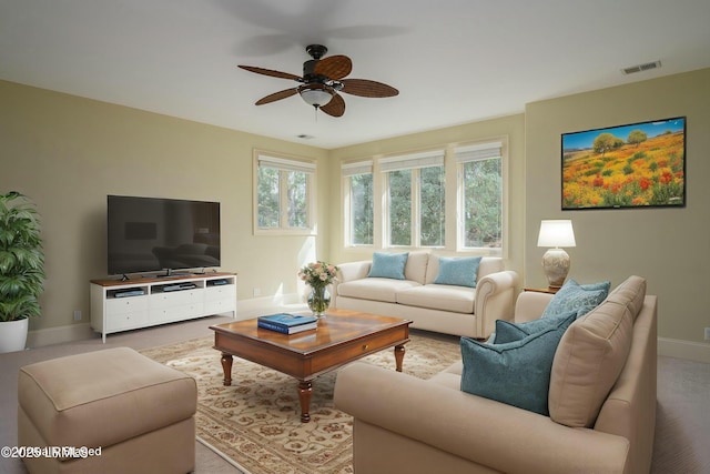 carpeted living area with ceiling fan, baseboards, and visible vents
