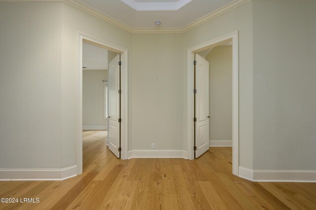 hall featuring ornamental molding and light hardwood / wood-style floors