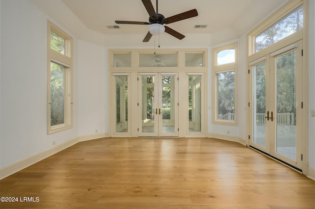 unfurnished sunroom with french doors and ceiling fan