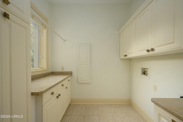 laundry area with cabinets, washer hookup, and light tile patterned floors