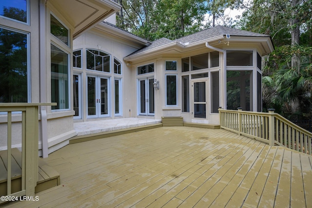 deck with a sunroom and french doors