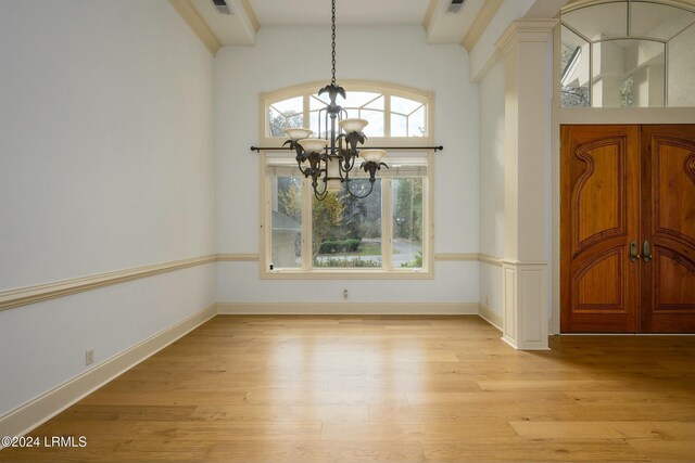 entrance foyer with an inviting chandelier and light wood-type flooring