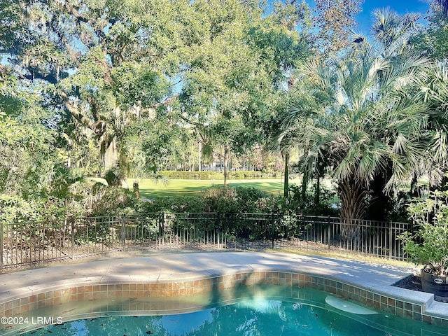 view of pool featuring a swimming pool and fence