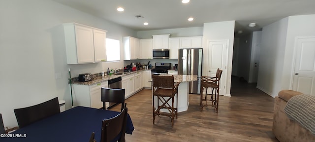 12 Pacolet Ln, Beaufort, SC 29906 - kitchen featuring stainless steel appliances, a kitchen breakfast bar, white cabinetry, a center island, and dark wood-style flooring