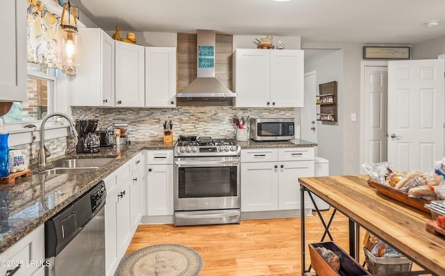 701 Battery Creek Rd, Beaufort, SC 29902 - kitchen with light wood finished floors, wall chimney range hood, appliances with stainless steel finishes, white cabinetry, and a sink