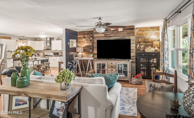 701 Battery Creek Rd, Beaufort, SC 29902 - living room with light wood-type flooring, wooden walls, and a ceiling fan