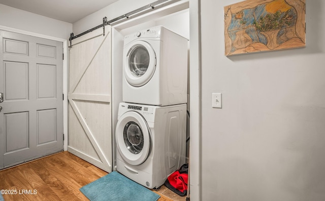 701 Battery Creek Rd, Beaufort, SC 29902 - washroom featuring a barn door, stacked washer and dryer, laundry area, and light wood finished floors