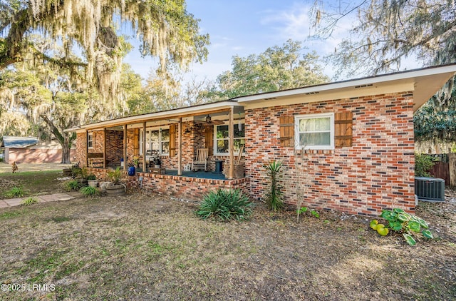 701 Battery Creek Rd, Beaufort, SC 29902 - view of front facade with brick siding, central AC unit, covered porch, and a ceiling fan
