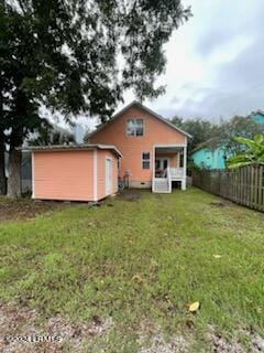 back of house featuring a yard