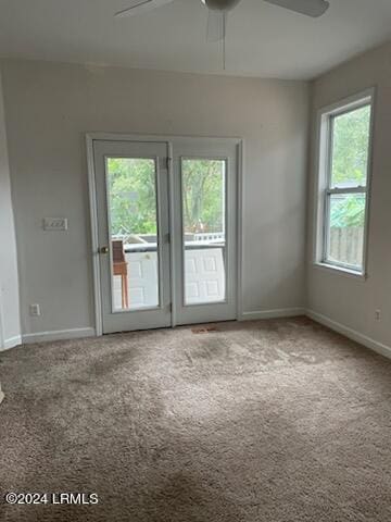 empty room featuring carpet flooring and ceiling fan