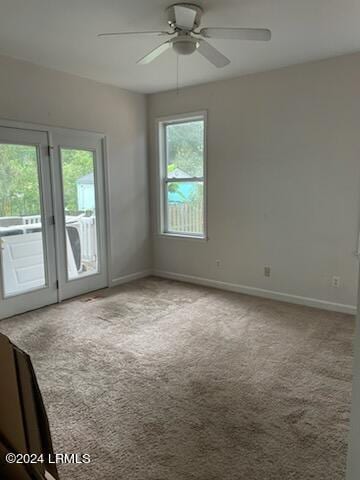 spare room featuring carpet and ceiling fan