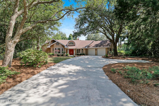 13 Annabella Ln, Hilton Head Island, SC 29926 - view of front of property with a garage, concrete driveway, and a chimney