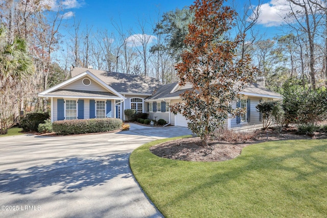 view of front of house with a garage and a front yard