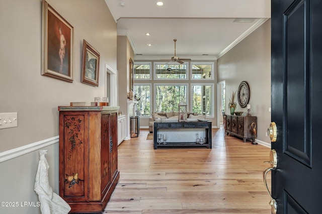 entryway featuring crown molding, ceiling fan, and light hardwood / wood-style flooring