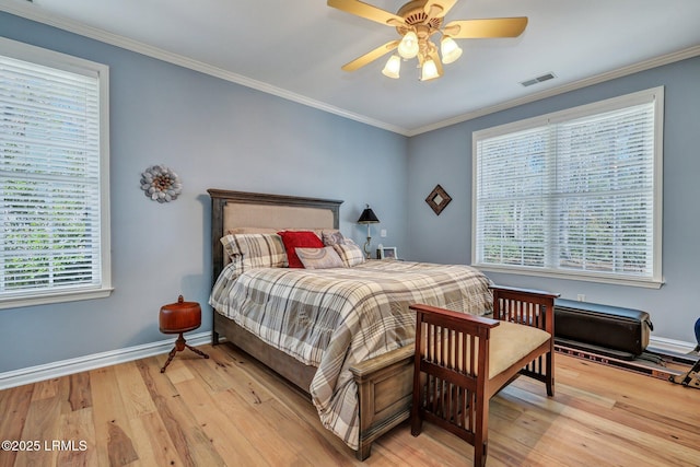 bedroom with crown molding and light hardwood / wood-style flooring