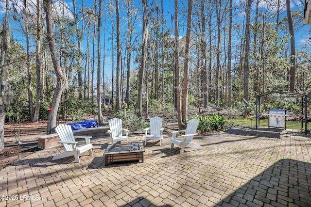 view of patio featuring a grill and a fire pit