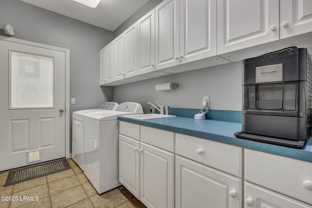 laundry area with cabinets, sink, and washer and dryer