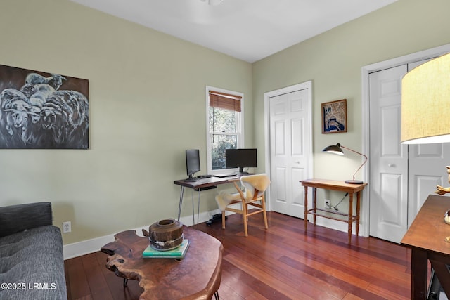 home office with dark hardwood / wood-style floors