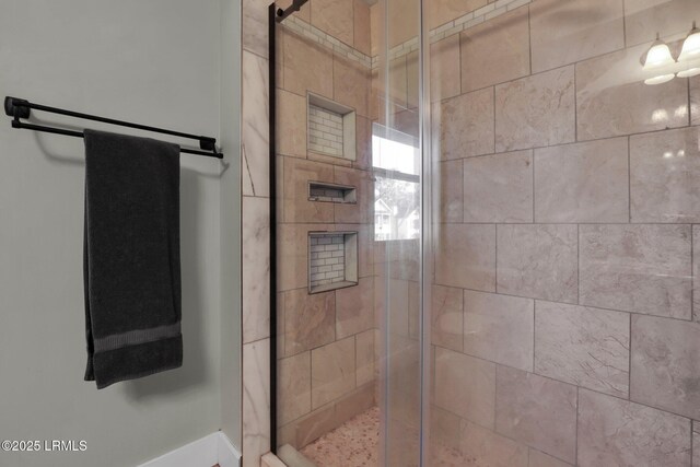 bathroom with a shower with shower door